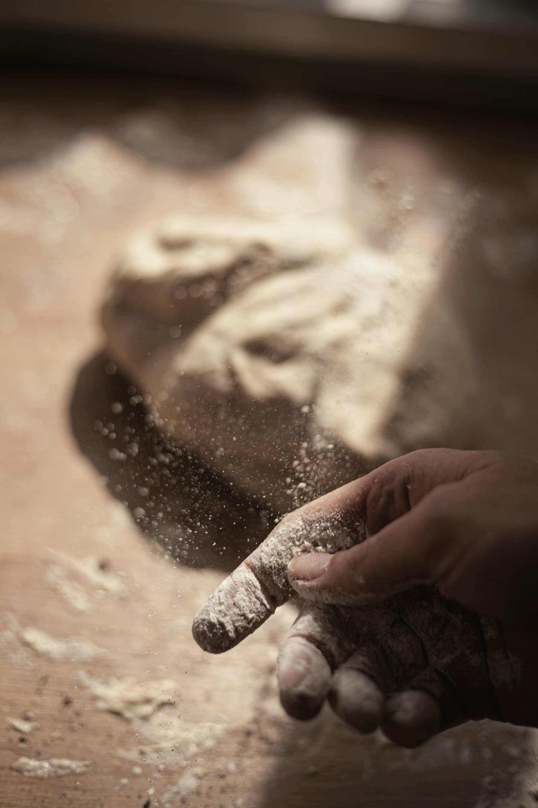 Hands shaping dough, black and white
