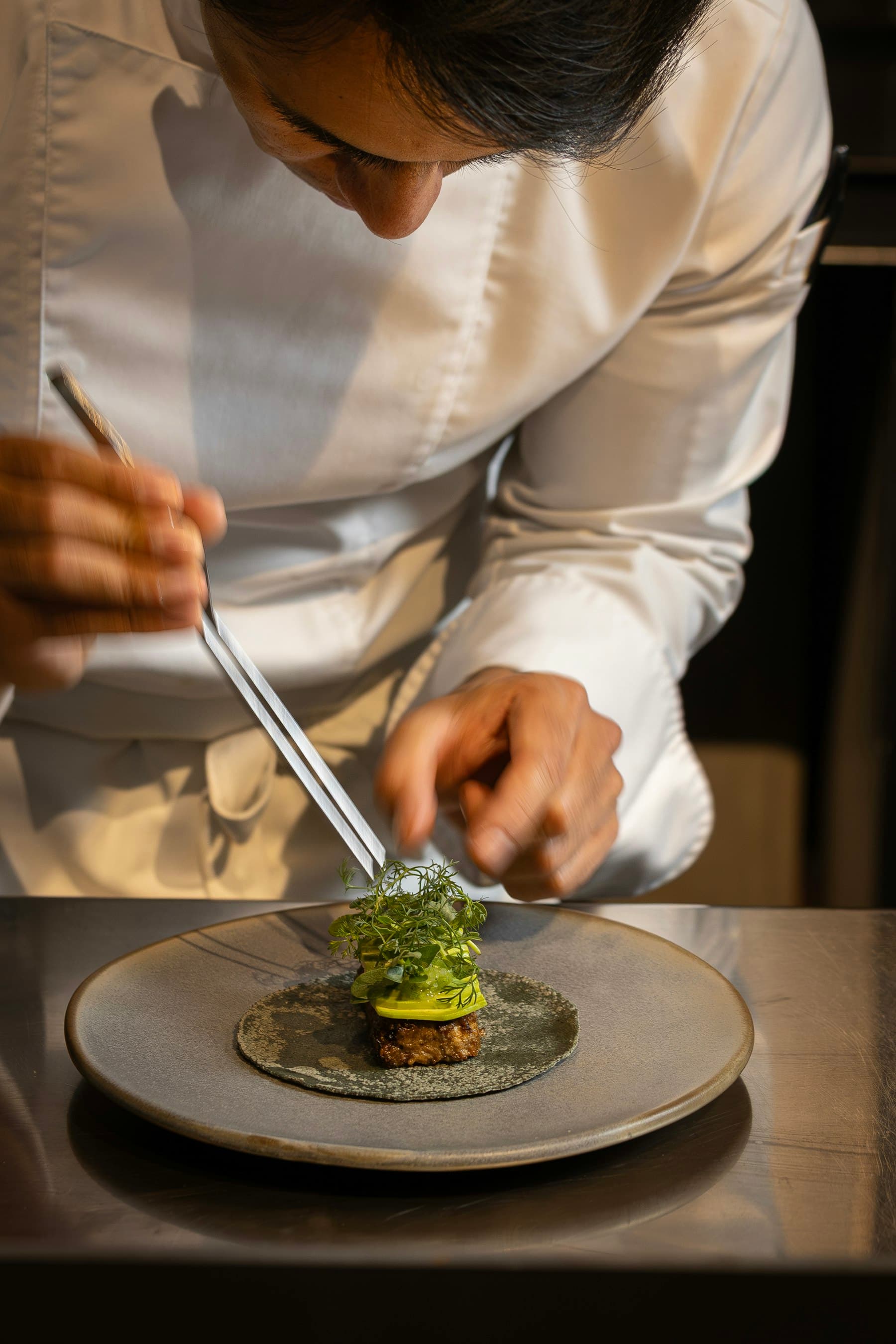 Chef plating langoustine, close