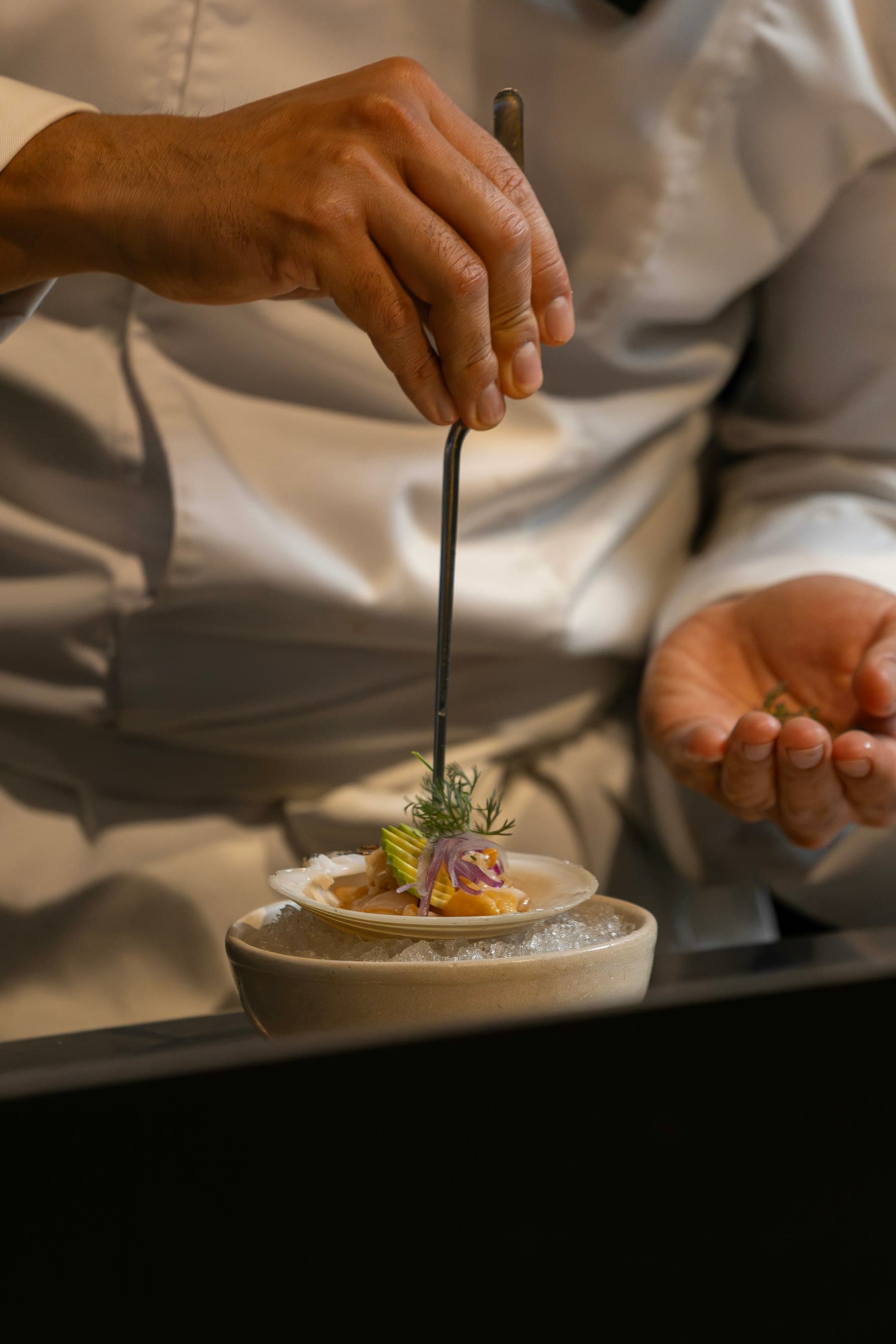 Hands plating a course