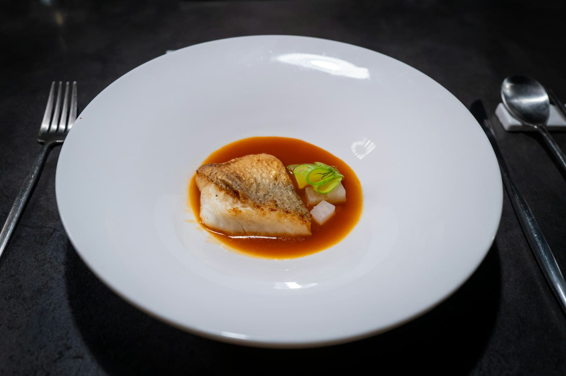 Turbot fillet in glossy sauce, mussels, dark linen